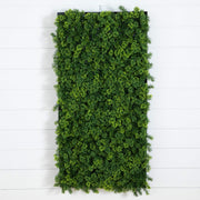 A rectangular artificial green hedge wall mounted on a white shiplap wall, featuring dense faux foliage in various shades of green.