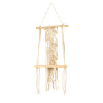 Macrame wall hanging with natural fibers on a white background