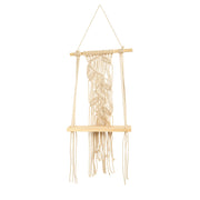 Macrame wall hanging with natural fibers on a white background