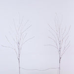 Two bare artificial tree branches with thin wire strands, set against a plain light gray background.