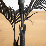 Black artificial palm tree for spooky Halloween home décor.