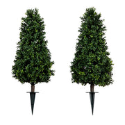 Two artificial trees with stakes on a white background