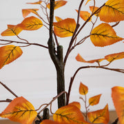 Artificial autumn leaf branch with orange leaves on a white background