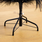Close-up of a black swivel stool base with a padded black seat cushion and metal support legs, shown on a light wood floor.