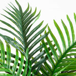 Artificial palm tree with green fronds and realistic brown double trunks.