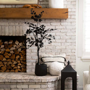 Decorative elements on a stone fireplace with a white brick wall background