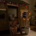 Lighted Valentine's Day artificial tree with red berry accents.