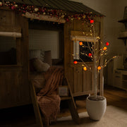 Lighted Valentine's Day artificial tree with red berry accents.