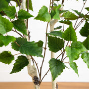Artificial green leaves with white stems on a plain background