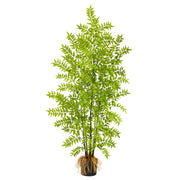 Artificial potted plant with green leaves on a white background