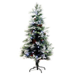 A pre-lit artificial Christmas tree with a white snow-dusted finish, decorated with pinecones and blue and white lights, standing on a black metal stand against a solid white background.