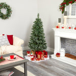 Decorated living room with Christmas tree, presents, and fireplace.