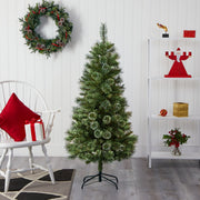 Decorated room with a Christmas tree, wreath, and festive decor.
