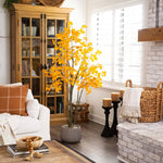 Living room with a white armchair, wooden cabinet, and decorative elements.