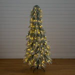 Green artificial Christmas tree with snowy white flocked branches