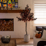 Living room with a decorated tree, Halloween decorations, and a fireplace.