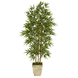 Artificial bamboo plant in a pot on a white background