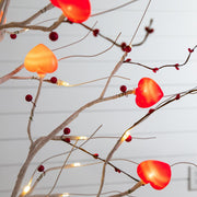 Six-foot white decorative tree with glowing red and pink heart ornaments.