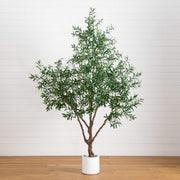 Potted artificial olive tree on a wooden floor with a white wall background