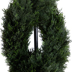 Green artificial wreath on a white background