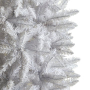 Close-up of a white artificial Christmas tree with detailed branches.