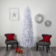 White Christmas tree in a room with gray chairs, red pillows, and decorative wreaths on a white wall.