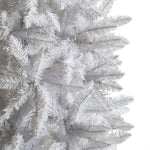 Close-up of a white artificial Christmas tree with detailed branches.