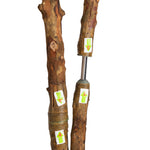Two wooden sticks with metal spikes on a white background