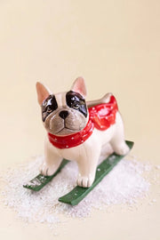 Glazed ceramic skiing dog sculpture for mantels, shelves and holiday displays