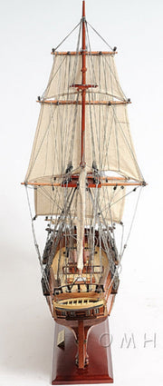 Model of a tall ship with multiple masts and sails on a white background