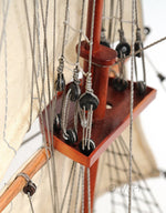 Close-up of a model ship with rigging and wooden details