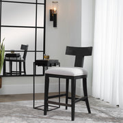 Contemporary wooden counter stool with cushioned black seat by Uttermost
